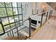View of the foyer featuring a two-story window, modern chandelier, and staircase with metal railing at 4806 W Euclid Ave, Tampa, FL 33629