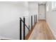 Hallway with modern cable railing system and light wood-look flooring at 4806 W Euclid Ave, Tampa, FL 33629