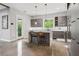 A modern kitchen showcasing sleek grey cabinets, a center island with seating, and bright natural light at 4806 W Euclid Ave, Tampa, FL 33629