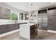 Open kitchen featuring stainless appliances, modern cabinetry, white countertops and a large central island with seating at 4806 W Euclid Ave, Tampa, FL 33629