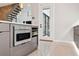 Kitchen with stainless steel microwave, wood cabinets, and view of staircase and covered outdoor seating at 4806 W Euclid Ave, Tampa, FL 33629