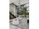 Bright, modern living room featuring floor-to-ceiling windows, hardwood stairs, and stylish decor at 4806 W Euclid Ave, Tampa, FL 33629