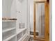 Mudroom with built-in shelving, seating, a decorative pillow, and a view into an adjacent room at 4806 W Euclid Ave, Tampa, FL 33629
