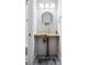 Compact powder room with a unique wood countertop, glass vessel sink, and stylish lighting at 4806 W Euclid Ave, Tampa, FL 33629