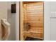 Cedar sauna features built-in benches, wood paneling, and traditional sauna stones at 4806 W Euclid Ave, Tampa, FL 33629