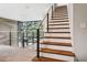 Elegant staircase with wood treads, white risers, and cable railing system at 4806 W Euclid Ave, Tampa, FL 33629