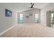 Empty bedroom is bright with neutral carpet, vaulted ceilings, and light gray walls at 4931 Pelican Dr, New Port Richey, FL 34652