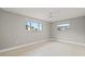 This simple bedroom features neutral paint, carpet, and two windows at 4931 Pelican Dr, New Port Richey, FL 34652
