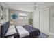 Comfortable bedroom features ceiling fan, closet, and gray walls with a white ceiling at 4931 Pelican Dr, New Port Richey, FL 34652