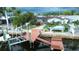 Waterfront home featuring a dock and boat lift, offering direct access to the open water and stunning views at 4931 Pelican Dr, New Port Richey, FL 34652