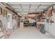 This garage features a wall of shelves and storage with a side door at 4931 Pelican Dr, New Port Richey, FL 34652