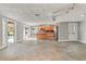 Open-concept living area with a view of the kitchen and outdoor pool through sliding glass doors, showcasing a bright interior at 4931 Pelican Dr, New Port Richey, FL 34652