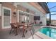 Outdoor patio featuring a dining table, chairs, and an adjacent pool at 4931 Pelican Dr, New Port Richey, FL 34652