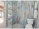 Nicely remodeled bathroom features tiled walk-in shower with glass enclosure and mosaic floor at 4931 Pelican Dr, New Port Richey, FL 34652