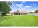 Expansive backyard featuring lush green grass, a privacy fence, and patio at 5013 119Th E Ter, Parrish, FL 34219