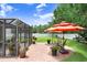 Brick patio with outdoor seating and umbrella, perfect for relaxing at 5013 119Th E Ter, Parrish, FL 34219