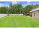 Large, grassy backyard with a privacy fence and a cozy screened patio area at 5013 119Th E Ter, Parrish, FL 34219