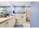 Well-lit bathroom featuring a combination tub and shower, tile flooring, and a vanity with ample storage at 5013 119Th E Ter, Parrish, FL 34219
