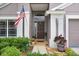 Inviting front entrance with American flag, well-kept landscaping and a brown front door at 5013 119Th E Ter, Parrish, FL 34219