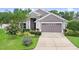Charming single-story home featuring a well-manicured lawn and a two car garage at 5013 119Th E Ter, Parrish, FL 34219