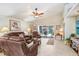 Comfortable living room boasts tile floors, a ceiling fan, and sliding doors to the backyard at 5013 119Th E Ter, Parrish, FL 34219