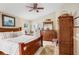 Tranquil main bedroom features a wooden bed frame, soft natural light, and a ceiling fan at 5013 119Th E Ter, Parrish, FL 34219