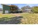 Spacious backyard featuring a covered deck and a screened in pool at 5657 Oceanic Rd, Holiday, FL 34690