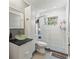 Modern bathroom featuring glass bowl sink, sleek white vanity, and tiled walk-in shower at 5657 Oceanic Rd, Holiday, FL 34690
