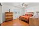 Stylish bedroom with hardwood floors, modern wooden furniture, and large window views at 5657 Oceanic Rd, Holiday, FL 34690