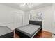 Cozy bedroom featuring hardwood floors, closet and a window offering natural light at 5657 Oceanic Rd, Holiday, FL 34690