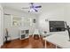 Bright bedroom with hardwood floors, guitar, sports decor, and natural light at 5657 Oceanic Rd, Holiday, FL 34690