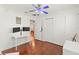 Bright bedroom with hardwood floors, a closet, and dual monitor setup on a white desk at 5657 Oceanic Rd, Holiday, FL 34690