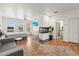 Bright bedroom boasts a fireplace, wood floors, and cozy sitting area with a grey sofa at 5657 Oceanic Rd, Holiday, FL 34690