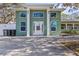 The home features a grand entrance with an inviting front door and stylish architectural accents at 5657 Oceanic Rd, Holiday, FL 34690