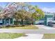 Two-story home with a well-manicured lawn, mature trees, a two-car garage and boat parking at 5657 Oceanic Rd, Holiday, FL 34690