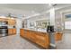 Well-lit kitchen showcasing a large island with ample storage and modern appliances at 5657 Oceanic Rd, Holiday, FL 34690
