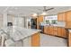 Open kitchen with granite countertops, stainless steel appliances, and bar seating at 5657 Oceanic Rd, Holiday, FL 34690