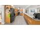 Spacious kitchen with stainless steel appliances, island, and tile flooring at 5657 Oceanic Rd, Holiday, FL 34690