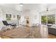 Open-concept living room with wood floors and views of the patio and surrounding nature at 5657 Oceanic Rd, Holiday, FL 34690