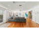 Bright living room with hardwood floors, fireplace, ceiling fans, and large gray sofa at 5657 Oceanic Rd, Holiday, FL 34690