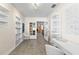 Bright office space featuring built-in shelving, french doors, and neutral tile flooring at 5657 Oceanic Rd, Holiday, FL 34690