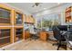 Home office with custom cabinetry, spacious desks, and a large window for natural light at 5657 Oceanic Rd, Holiday, FL 34690