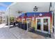 A vibrant, covered patio area with a painted mural, outdoor seating, and access to the pool at 5657 Oceanic Rd, Holiday, FL 34690