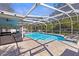 Sparkling screened-in pool with outdoor seating, perfect for relaxation and entertaining at 5657 Oceanic Rd, Holiday, FL 34690