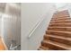 Stairway with wood steps and a white railing in a well-lit home at 5657 Oceanic Rd, Holiday, FL 34690
