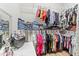 Large walk-in closet featuring rods and shelves for clothes and storage with a makeup area at 5657 Oceanic Rd, Holiday, FL 34690