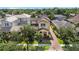 Aerial view of home showing driveway, mature landscaping, and proximity to neighboring houses at 6113 Yeats Manor Dr, Tampa, FL 33616