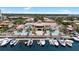 Aerial view of a community building with marina and dock, surrounded by palm trees and waterfront views at 6113 Yeats Manor Dr, Tampa, FL 33616