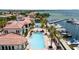Aerial view showcasing swimming pool, marina with yachts, and waterfront residences under a sunny sky at 6113 Yeats Manor Dr, Tampa, FL 33616