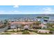 Aerial view of a building with red tile roof, palms trees, a marina and waterfront in the background at 6113 Yeats Manor Dr, Tampa, FL 33616